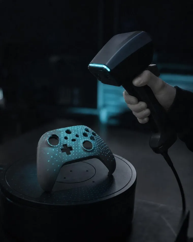 A handheld 3D scanner scanning a controller housing